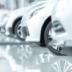 Cars For Sale, Automotive Industry, Cars Dealership Parking Lot. Rows of Brand New Vehicles Awaiting New Owners, on the epoxy floor in new car service
