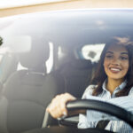 Happy woman driving vehicle
