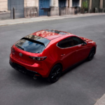 2026 MAZDA3 Hatchback driving on city street