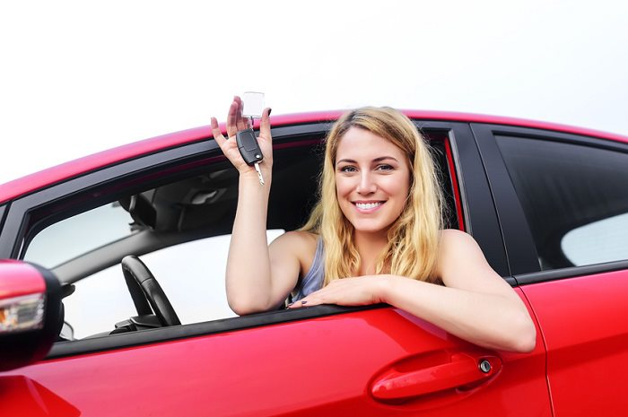 Driver showing keys of a car