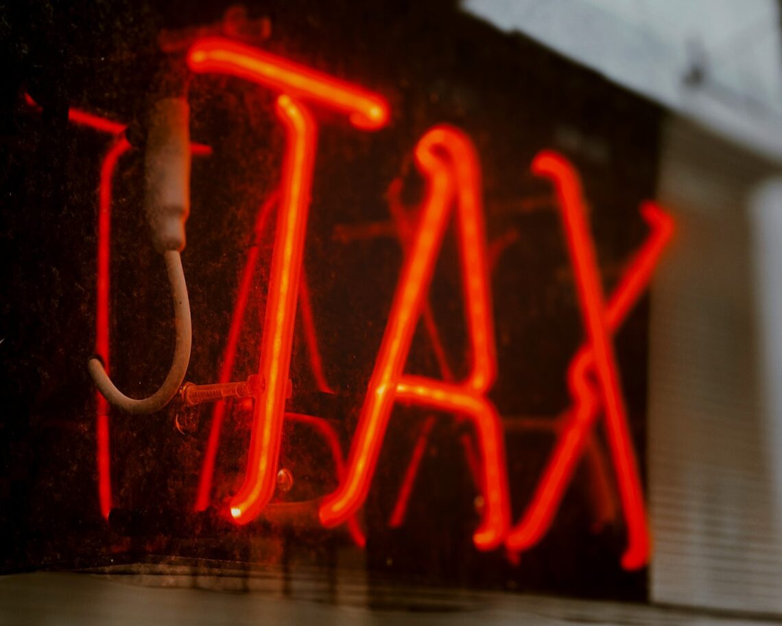Neon sign that says "TAX"